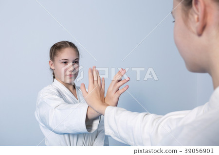 Two girls in black hakama practice Aikido Two girls in black hakama practice Aikido 39056901