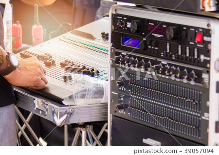 DJ are using their hands to adjust the volume 39057094