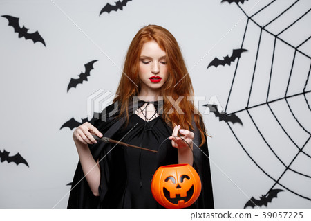 Portrait of beautiful caucasian witch holding Portrait of beautiful caucasian witch holding 39057225
