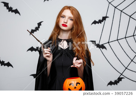 Portrait of beautiful caucasian witch holding Portrait of beautiful caucasian witch holding 39057226