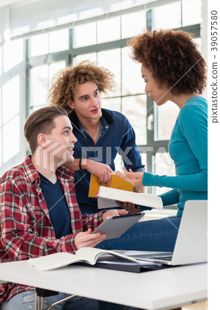 Three involved students sharing ideas and opinions 39057580