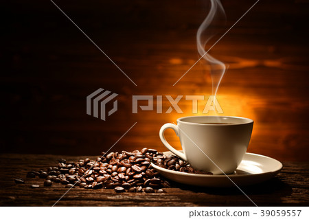 Cup of coffee with smoke and coffee beans Cup of coffee with smoke and coffee beans 39059557