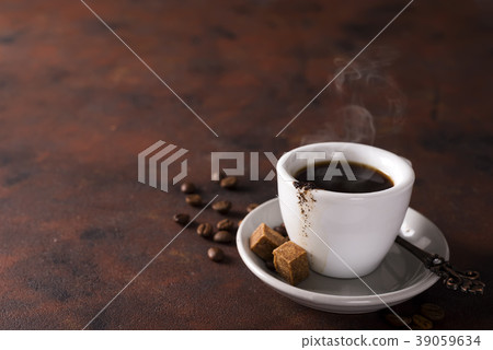 cup of black coffee on a saucer with brown sugar cup of black coffee on a saucer with brown sugar 39059634
