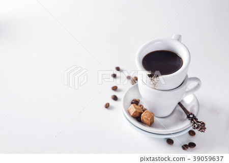 cup of black coffee on a saucer with brown sugar cup of black coffee on a saucer with brown sugar 39059637