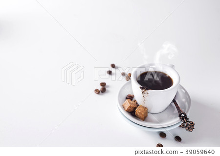 cup of black coffee on a saucer with brown sugar cup of black coffee on a saucer with brown sugar 39059640