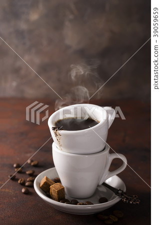 cup of black coffee on a saucer with brown sugar 39059659