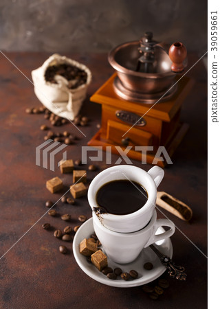 Cup of steaming hot coffee with coffee beans 39059661