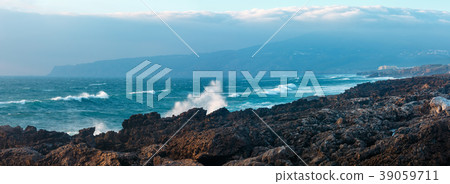 Waves breaking on rocky coast. 39059711