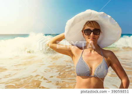Woman in hat on the beach Woman in hat on the beach 39059851
