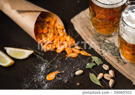Beer mug and grilled shrimps on wooden table Beer mug and grilled shrimps on wooden table 39060503