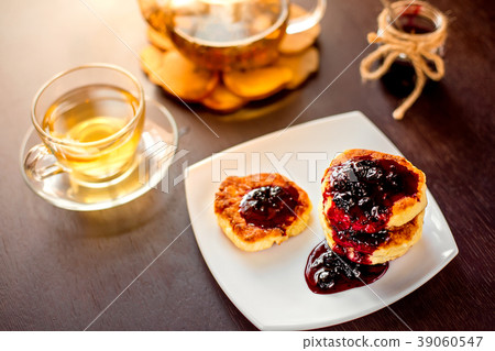 sweet cheese pancakes on a white plate with green 39060547