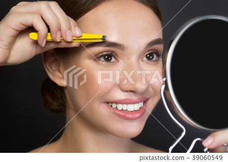 Cheerful attractive girl is holding pincers Cheerful attractive girl is holding pincers 39060549