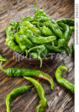 green chili peppers placed in a clay plate o 39061013