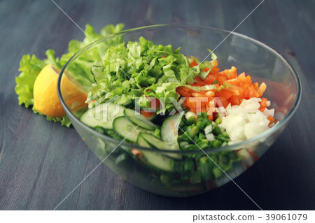 Glass bowl with cutted vegetables for a salad. 39061079