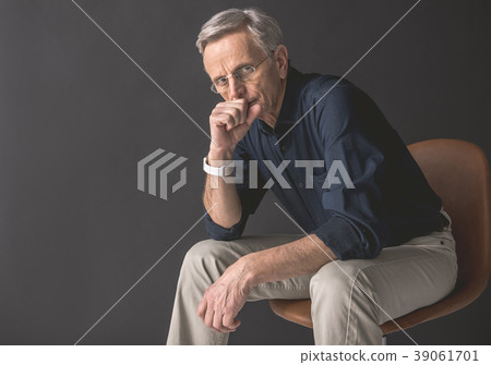 Pensive old man locating on seat Pensive old man locating on seat 39061701