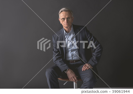 Serene old businessman relaxing on seat Serene old businessman relaxing on seat 39061944
