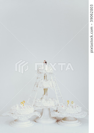 Multi-tier white wedding cake. Multi-tier white wedding cake. 39062803