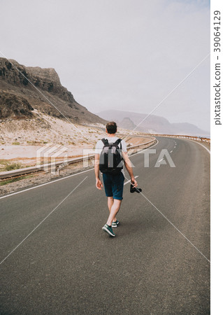 Traveler walks in the center of an epic winding Traveler walks in the center of an epic winding 39064129