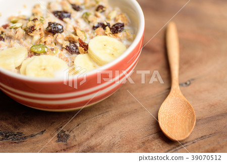 Muesli cereal with slice banana and spoon Muesli cereal with slice banana and spoon 39070512