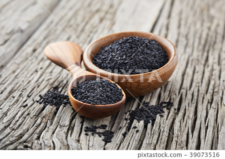 Black cumin on wooden background 39073516