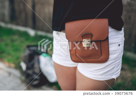 Ladies brown leather bag strapped to her hips 39073676