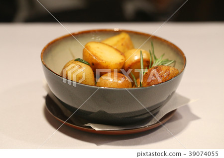 Photo of a bright tasty baked potato Photo of a bright tasty baked potato 39074055