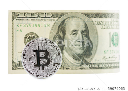 Bitcoin in front of one hundred dollar bill isolat 39074063