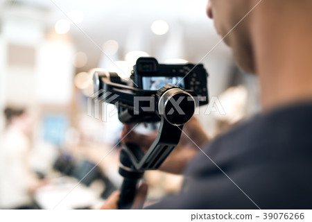 Videographer shooting using new steadycam camera 39076266
