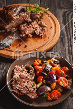 Roasted lamb fillet with oven baked vegetables. 39084724