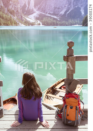 girl backpacker looking at Braies lake 39088174
