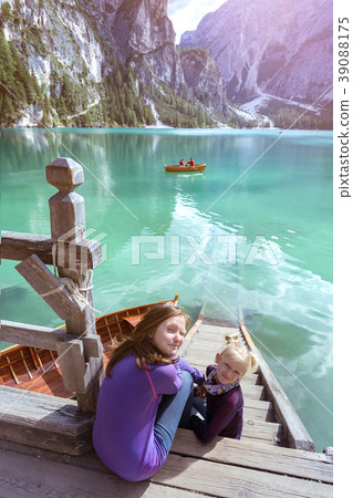 girl backpacker looking at Braies lake 39088175