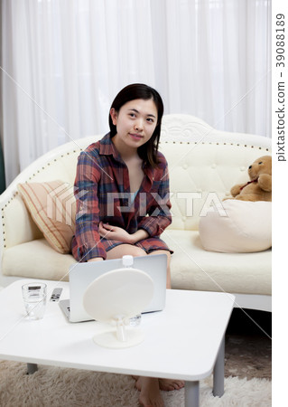 A young lady sitting on the sofa A young lady sitting on the sofa 39088189