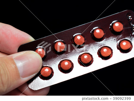 Packs of medicine on black background. 39092399