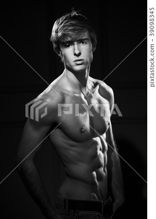 Muscular handsome man portrait at dark background 39098345
