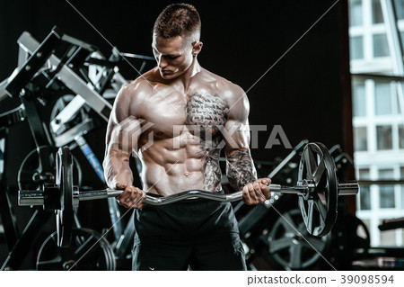 Handsome model young man working out in gym Handsome model young man working out in gym 39098594