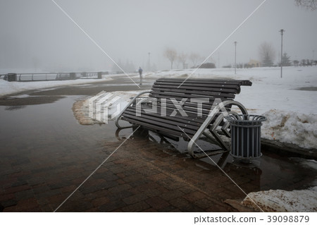 Empty bench in foggy park Empty bench in foggy park 39098879