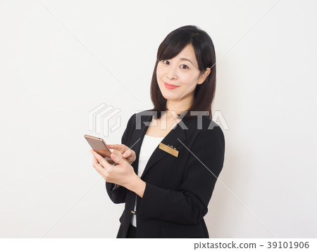 Businesswoman smiling with a smartphone Businesswoman smiling with a smartphone 39101906