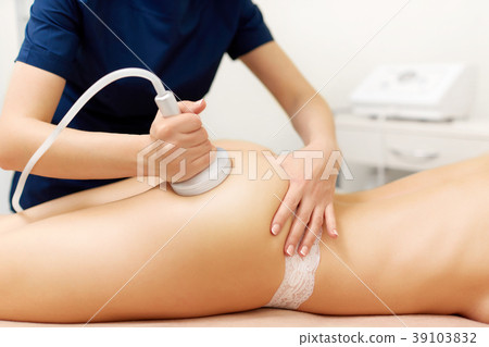 Cosmetology specialist massaging buttocks of naked Cosmetology specialist massaging buttocks of naked 39103832