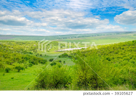 Green field and blue sky. Picturesque hills  39105627