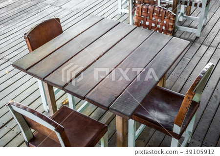 empty wooden table in restaurant four empty chairs 39105912