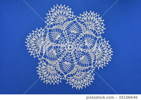 Crocheted lace napkin home decoration on blue 39106646