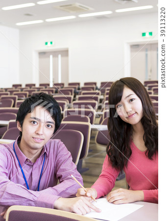 Young men teaching girl students in classroom 39113220