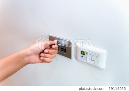 Close up of female hand inserting key card Close up of female hand inserting key card 39114933