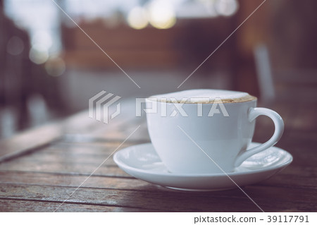 Hot coffee in white cup on wooden table 39117791