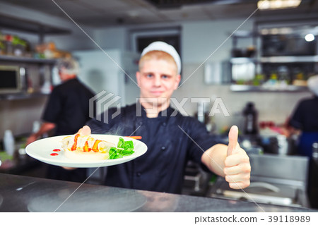 Waiters carrying plates with food, in restaurant. 39118989