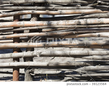 Detail of wicker fence close-up, brown. 39123564