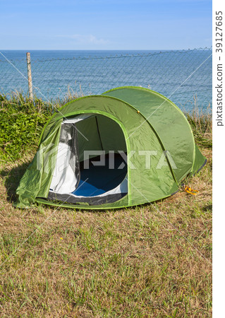 Green touristic tent near a sea by a sunny day Green touristic tent near a sea by a sunny day 39127685