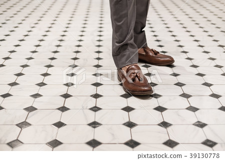 Close-up a man wearing brown leather shoes 39130778