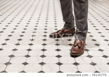 Close-up a man wearing brown leather shoes 39130779