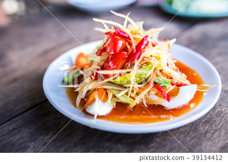 Papaya salad with salted egg on the plate. Papaya salad with salted egg on the plate. 39134412
